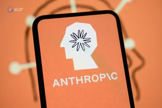 The Anthropic logo is displayed on the screen of a smartphone with the company's branding in the background.